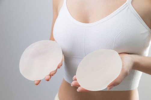 Female,Holding,Silicone,Breast,Implants,In,Hands